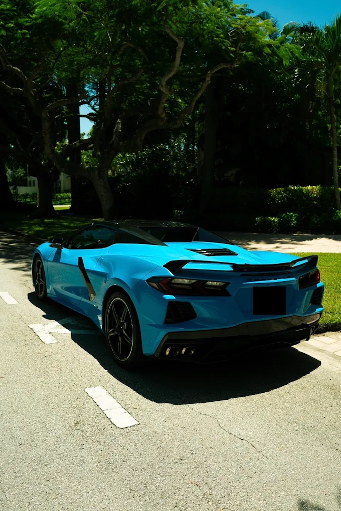 Turquoise Chevrolet Corvette C8, rear three-quarter view