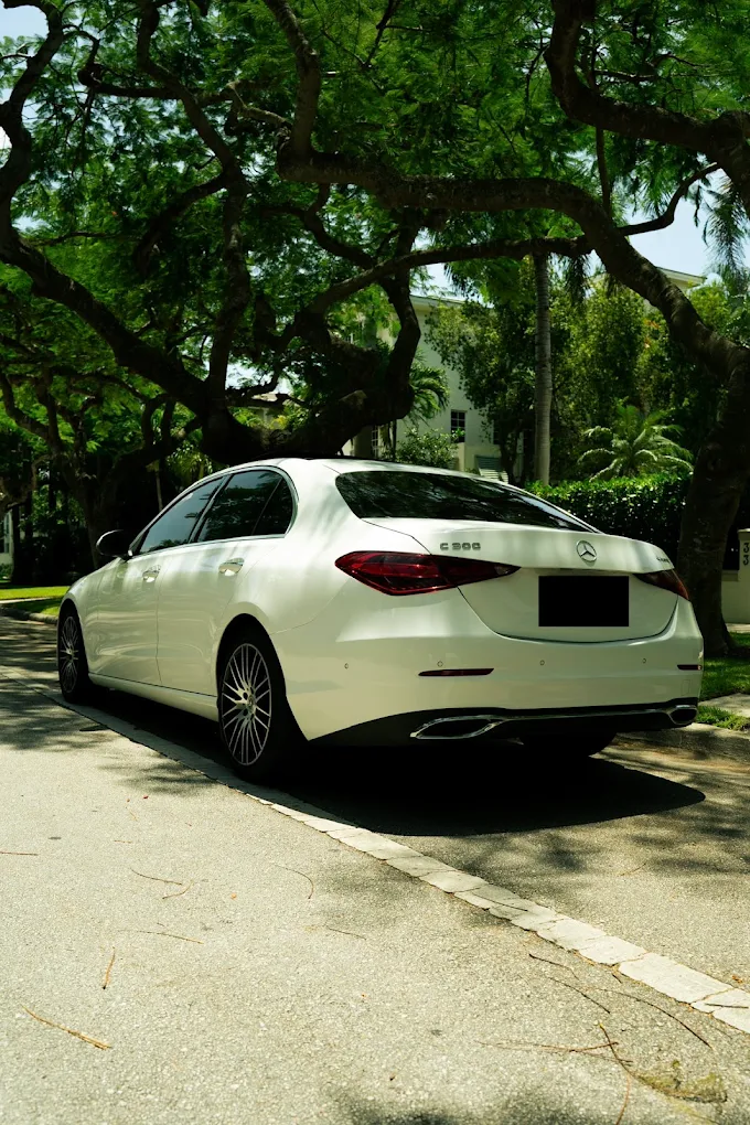 White Mercedes-Benz C300, rear three-quarter view