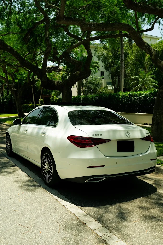 White Mercedes-Benz C300, rear side view